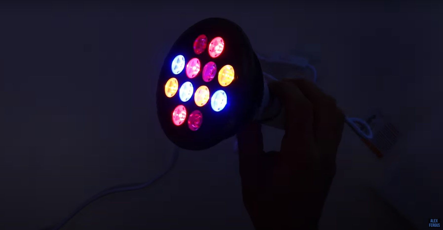 Handheld light therapy device glowing with multiple wavelengths
